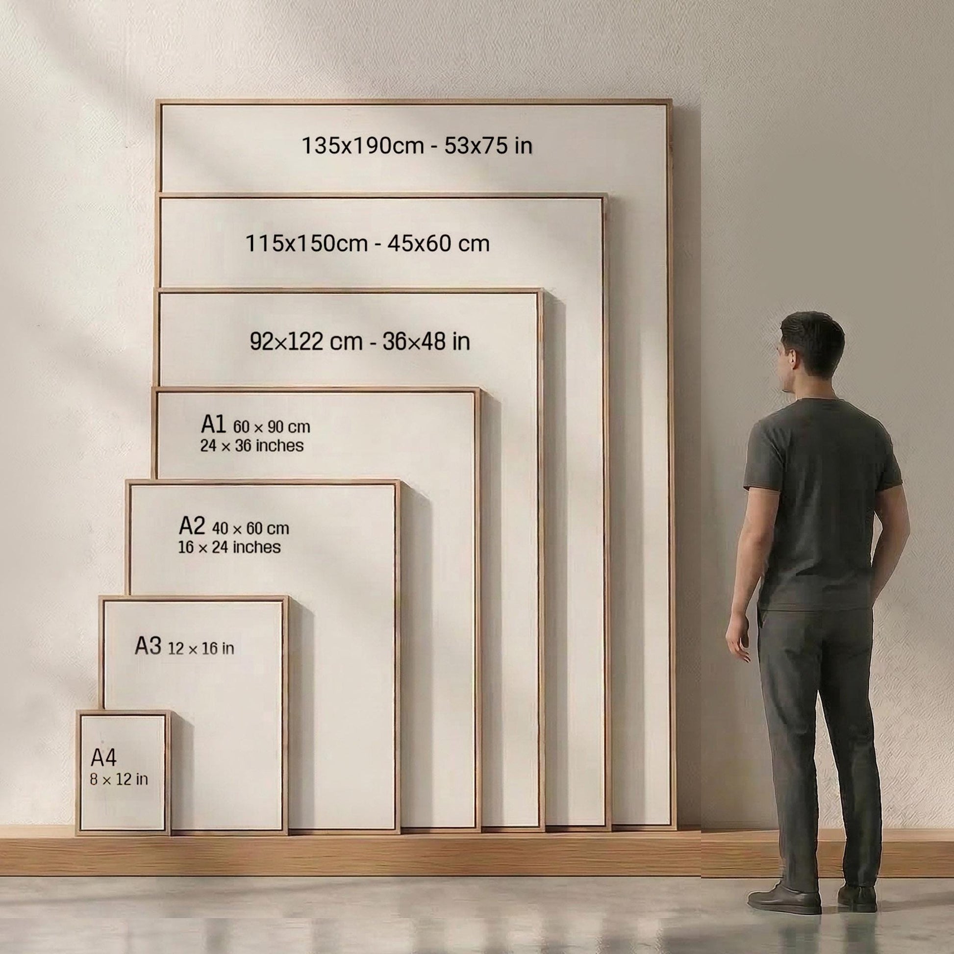 A man in a suit standing next to a large wooden frame with measurements for different sizes of frames.